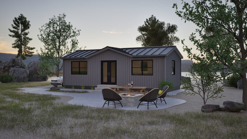 Modern gray tiny home in serene lakeside setting with outdoor seating and fire pit.